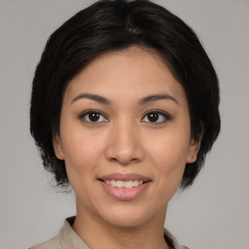 Joyful asian young-adult female with medium  black hair and brown eyes