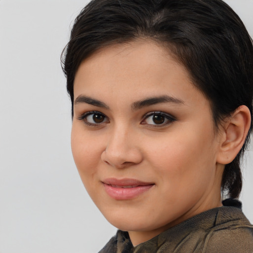 Joyful latino young-adult female with medium  brown hair and brown eyes