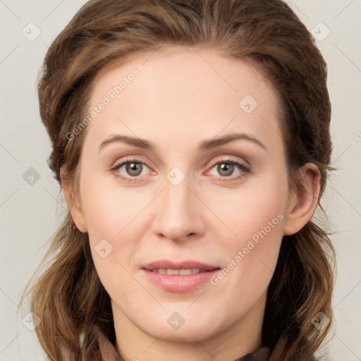 Joyful white young-adult female with medium  brown hair and green eyes