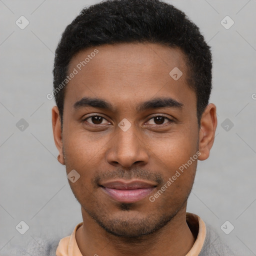 Joyful black young-adult male with short  black hair and brown eyes