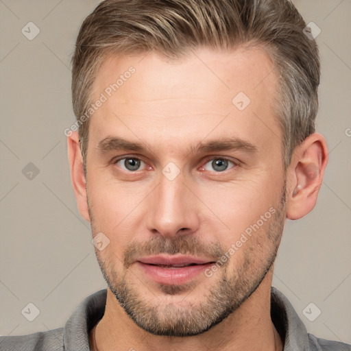 Joyful white adult male with short  brown hair and brown eyes