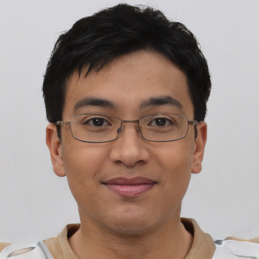 Joyful asian young-adult male with short  brown hair and brown eyes