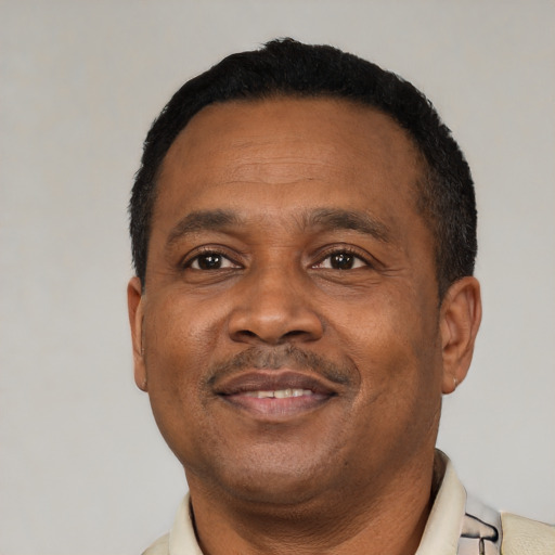 Joyful latino adult male with short  black hair and brown eyes