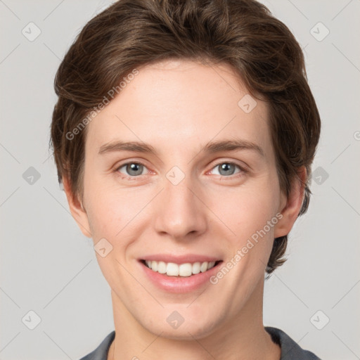 Joyful white young-adult female with short  brown hair and grey eyes