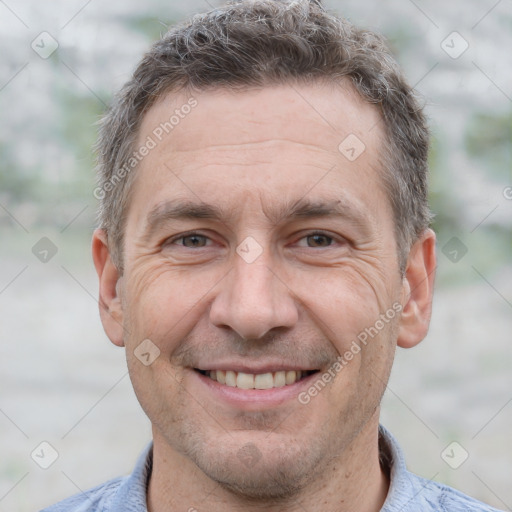 Joyful white adult male with short  brown hair and grey eyes