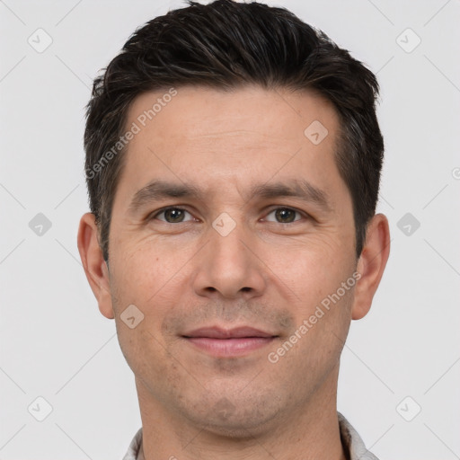 Joyful white adult male with short  brown hair and brown eyes