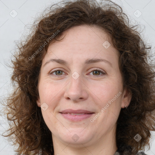 Joyful white adult female with medium  brown hair and green eyes