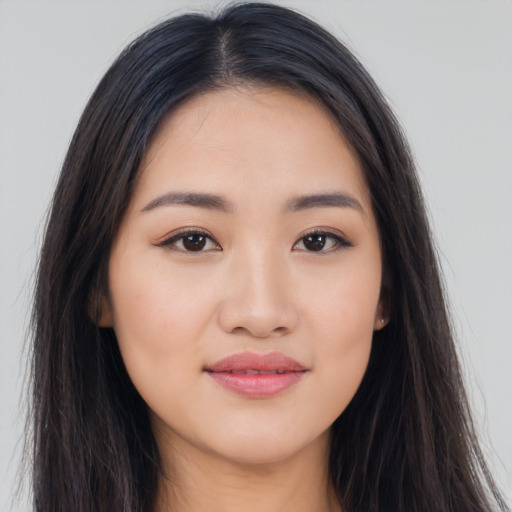 Joyful asian young-adult female with long  brown hair and brown eyes