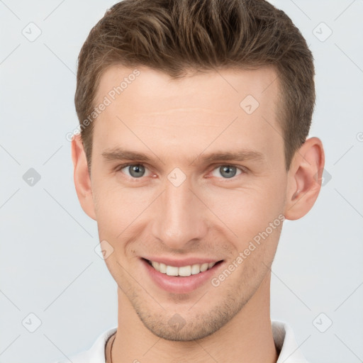 Joyful white young-adult male with short  brown hair and grey eyes