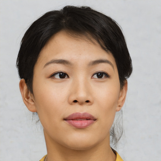 Joyful asian young-adult female with short  brown hair and brown eyes