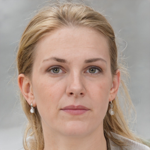 Joyful white adult female with medium  brown hair and grey eyes