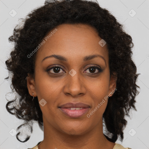 Joyful black adult female with medium  brown hair and brown eyes