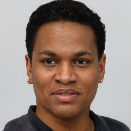 Joyful black young-adult male with short  black hair and brown eyes