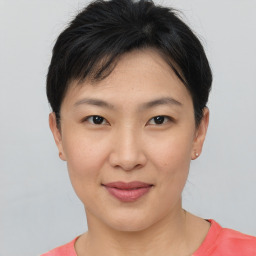 Joyful asian young-adult female with short  brown hair and brown eyes