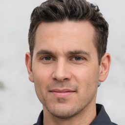 Joyful white young-adult male with short  brown hair and brown eyes