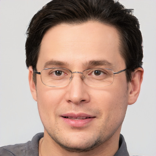 Joyful white adult male with short  brown hair and brown eyes