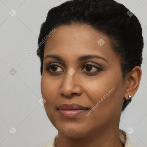 Joyful black young-adult female with short  black hair and brown eyes