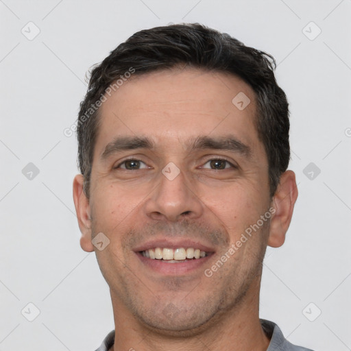 Joyful white adult male with short  brown hair and brown eyes