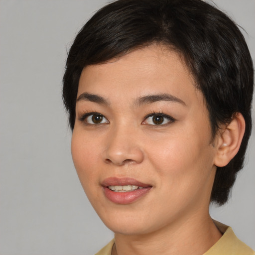 Joyful asian young-adult female with medium  brown hair and brown eyes