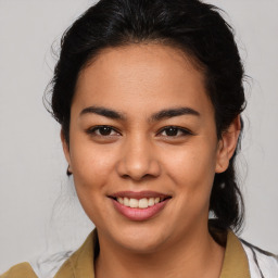 Joyful latino young-adult female with medium  brown hair and brown eyes