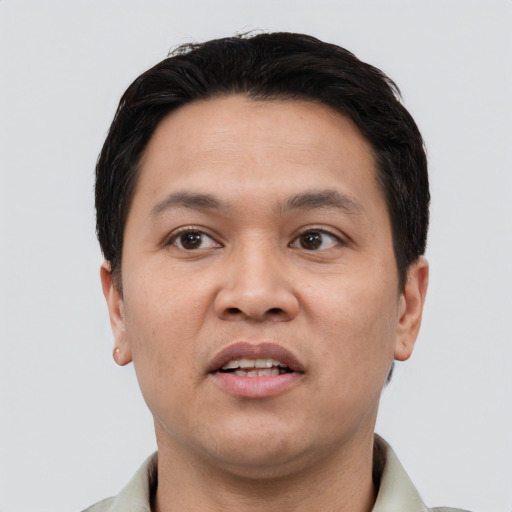 Joyful white young-adult male with short  black hair and brown eyes