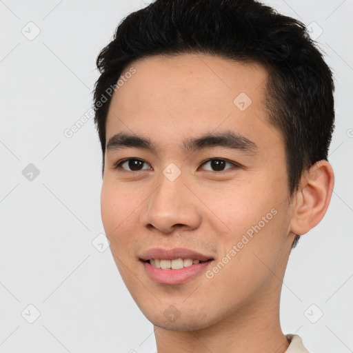 Joyful asian young-adult male with short  brown hair and brown eyes