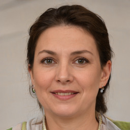 Joyful white adult female with medium  brown hair and grey eyes