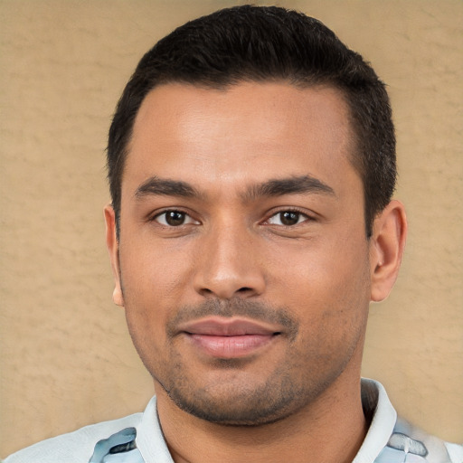 Joyful white young-adult male with short  black hair and brown eyes