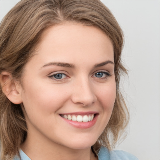 Joyful white young-adult female with medium  brown hair and blue eyes