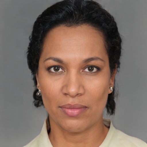 Neutral latino adult female with short  brown hair and brown eyes