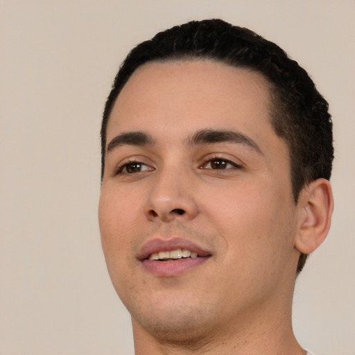 Joyful white young-adult male with short  black hair and brown eyes