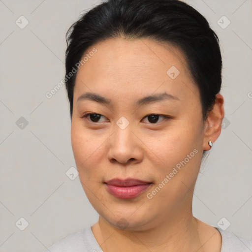 Joyful asian young-adult female with short  black hair and brown eyes