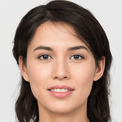 Joyful white young-adult female with long  brown hair and brown eyes