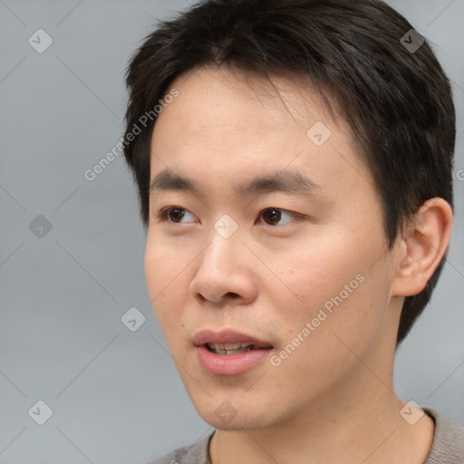 Neutral asian young-adult male with short  brown hair and brown eyes