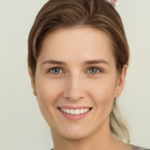 Joyful white young-adult female with short  brown hair and grey eyes