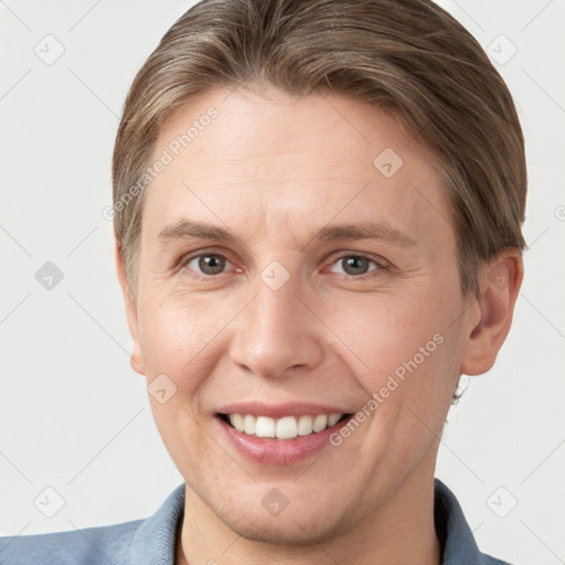 Joyful white adult female with short  brown hair and grey eyes