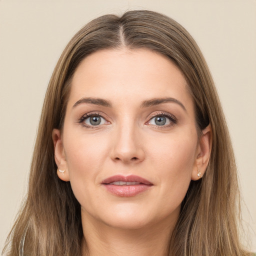 Joyful white young-adult female with long  brown hair and grey eyes