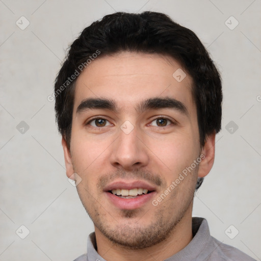 Joyful white young-adult male with short  black hair and brown eyes