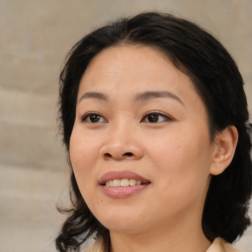 Joyful asian young-adult female with medium  black hair and brown eyes