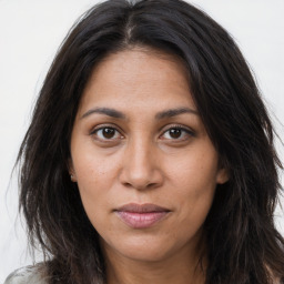 Joyful asian young-adult female with long  brown hair and brown eyes