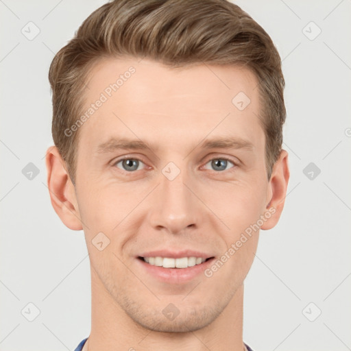 Joyful white young-adult male with short  brown hair and grey eyes