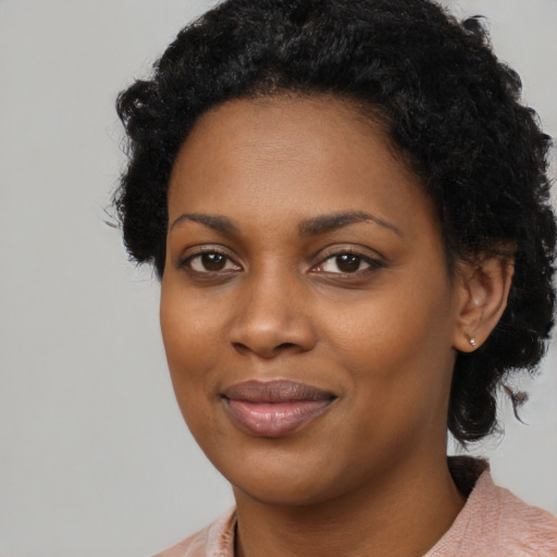 Joyful black young-adult female with medium  black hair and brown eyes