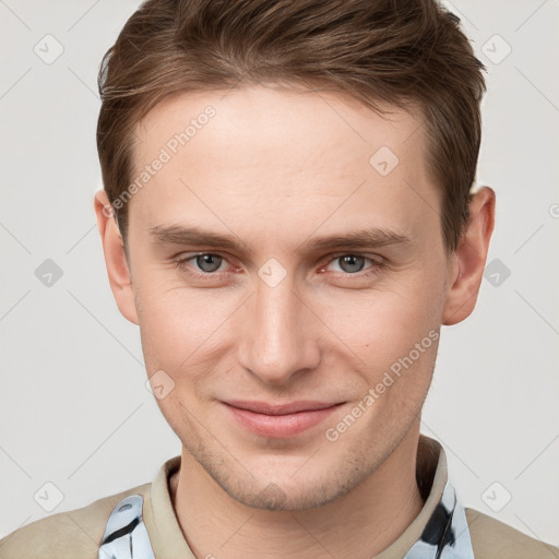 Joyful white young-adult male with short  brown hair and grey eyes