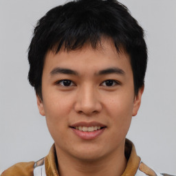 Joyful asian young-adult male with short  black hair and brown eyes