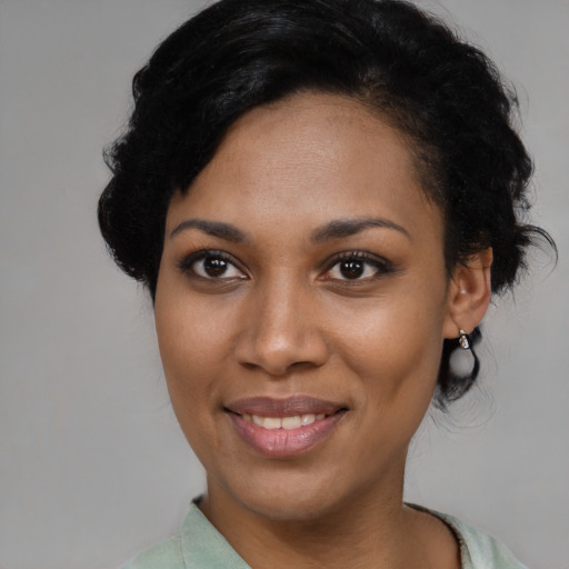 Joyful latino young-adult female with short  black hair and brown eyes