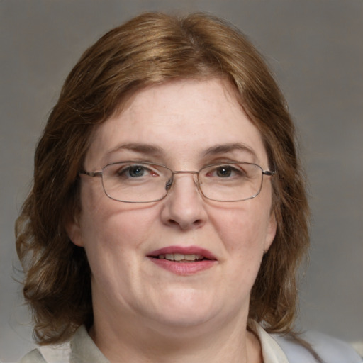 Joyful white adult female with medium  brown hair and blue eyes