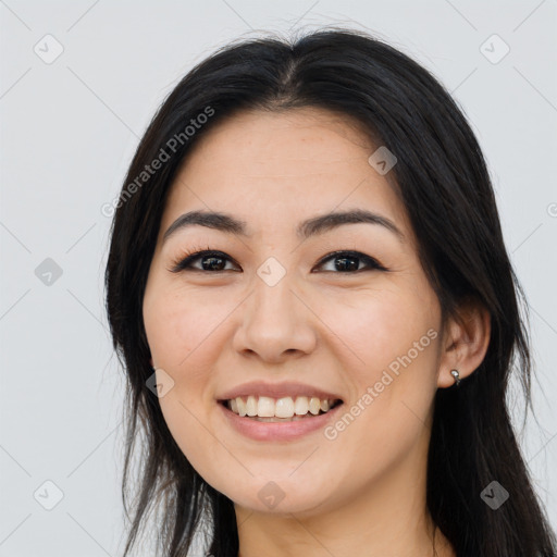 Joyful asian young-adult female with long  black hair and brown eyes