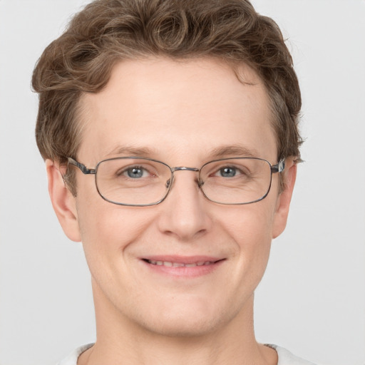 Joyful white adult male with short  brown hair and grey eyes