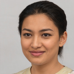 Joyful asian young-adult female with medium  brown hair and brown eyes