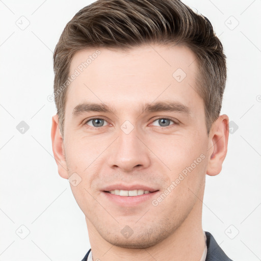 Joyful white young-adult male with short  brown hair and grey eyes